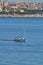 Close boat sailing near Cagliari marina.