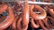 Close bottom-up footage of smoked sausages tied and hanging from a metal crossbar