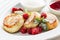 Close cheese pancakes, syrniki, curd fritters with fresh raspberries on white plate background