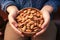 Close connection a childs hand cradles a bowl of almonds