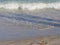 Close, cropped shot of waves breaking and foaming on the shores