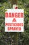 Close on Danger Pesticides Sprayed Sign