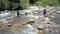 Close Drone View Men Fish in Shallow Water among Rapids