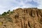 At close of the famous Stob Pyramids with unusual shape red and yellow rock formations, green bushes and trees around