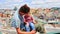 Close Father Little Girl Sit on High House Roof against City