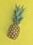 Close on fresh pineapple on yellow background