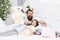 Close friends. Dad and girl relaxing in bedroom. Pajamas style. Father bearded man with funny hairstyle ponytails and
