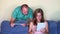 Close friends man and woman using personal tablet computer sitting on sofa