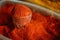 Close Glass With Powdered Paprika, Cayenne Pepper. Heap Of Bright Red Fragrant Spice