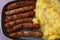 Close grilled Nuremberg sausages with potato