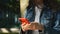 Close hands of a young girl and a red phone