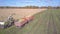 Close harvester pours corn foliage into almost full trailer