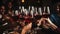 Close knit group of joyful friends toasting red wine glasses with smiles at a lively dinner party