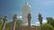 Close Large White Buddha Statue High Columns in Temple Park