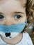 Close of Little Brazilian girl using mask on quarantine