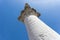 A close look at a fragment of an ancient antique Greek column towering into the sky. Close look up.