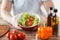 Close of male hand holding a bowl with salad