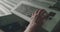 Close male hand typing on keyboard of the control desk during a factory workflow