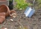 Close on a metal trowel planting in the soil