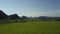 Close motion above peanut fields in valley under blue sky