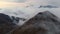 Close movement flies along endless mountains through the clouds. An aerial view of a landscape of clouds floats halfway