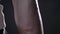 Close moving footage of black man`s vascular and strong hand, beautiful muscular body, black studio background