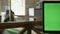 Close moving shot of laptop display with chromakey in office with working people