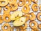 close of organic dried apple chips and fresh half apple with seeds on metal tray on white background