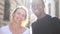 Close outdoor portrait of a happy man and woman. A black guy and a white girl are smiling. Black and white couple in