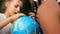 Close outdoor portrait of teens exploring a large globe. Travel concept, travel agency, back to school