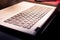 Close photograph of a laptop keyboard with sunlight. Concept workspace office