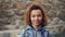 Close portrait of African American girl with light curly hair wearing casual clothing looking at camera and smiling