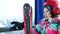 Close portrait on the background of snowy mountains. Girl teenager in a helmet and with skis climbs a mountain in the