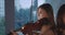 Close portrait of beautiful violinists duet playing music on background indoor