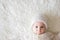 Close portrait of a little baby boy in white knitted onesie and