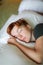 Close portrait of Redhead sleeping adult woman lies in white bed