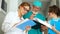 Close portrait of a young surgeon doctor and his two medical assistants. Clinic medical staff at work. Medicine and