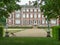 Close rear view of Ham House, framed by statues and trees