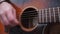 Close shoot of playing on old guitars\'s strings.