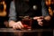 Close shot of an alcohol cocktail with chocolate in bartender`s hands