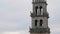 Close shot of The bells move and ring creating a sound that is heard throughout the region from the bell tower of the Basilica de