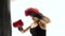 Close shot of female boxer makes blows to punching bag