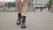 Close shot of female legs walking in heavy armi boots. Closeup shooting fashionable female in leather boots walk in