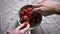 Close shot of hands grabbing strawberries from bowl