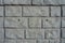Close shot of light gray unpainted brick veneer wall