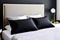 Close shot modern elegant geometric black pillows on a bed