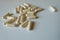 Close shot of multiple beige capsules of probiotic dietary supplement