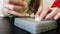 A close shot on a soft background and the hands of a craftswoman. Dry felting from wool. Laborious work. Fine motor skills. Hobby