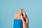 Close shot of a woman\'s hand in a blue knitted sweater