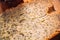 Close slice of fresh bread with poppy seeds on a wooden background